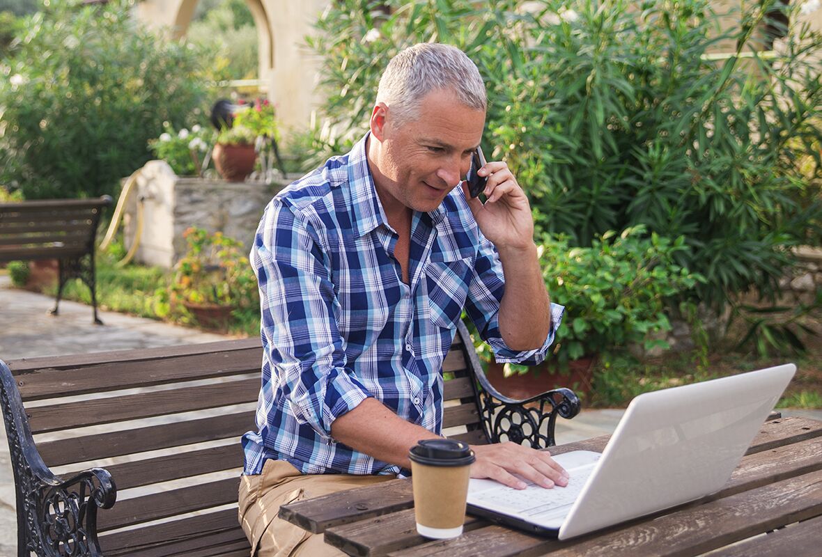 Young successful businessman working on a laptop while sitting i Prevent scammers phishing vishing
