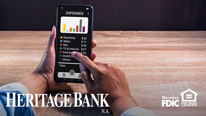 HBNA Blog- Budgeting Tips for Busy Families on the Go phone with bills